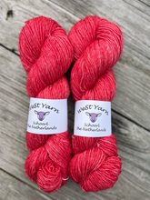 Load image into Gallery viewer, Two skeins of red yarn with West Yarn labels on a wooden surface